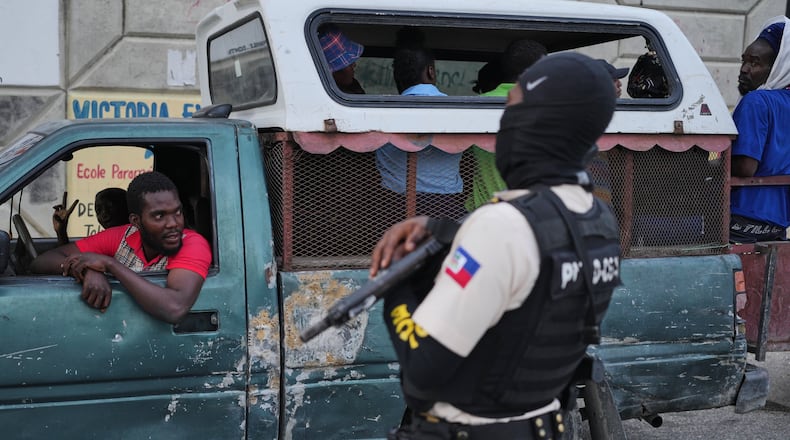 A police officer stands guard in Port-au-Prince, Haiti, Tuesday, March 3, 2026. (AP Photo/Odelyn Joseph)