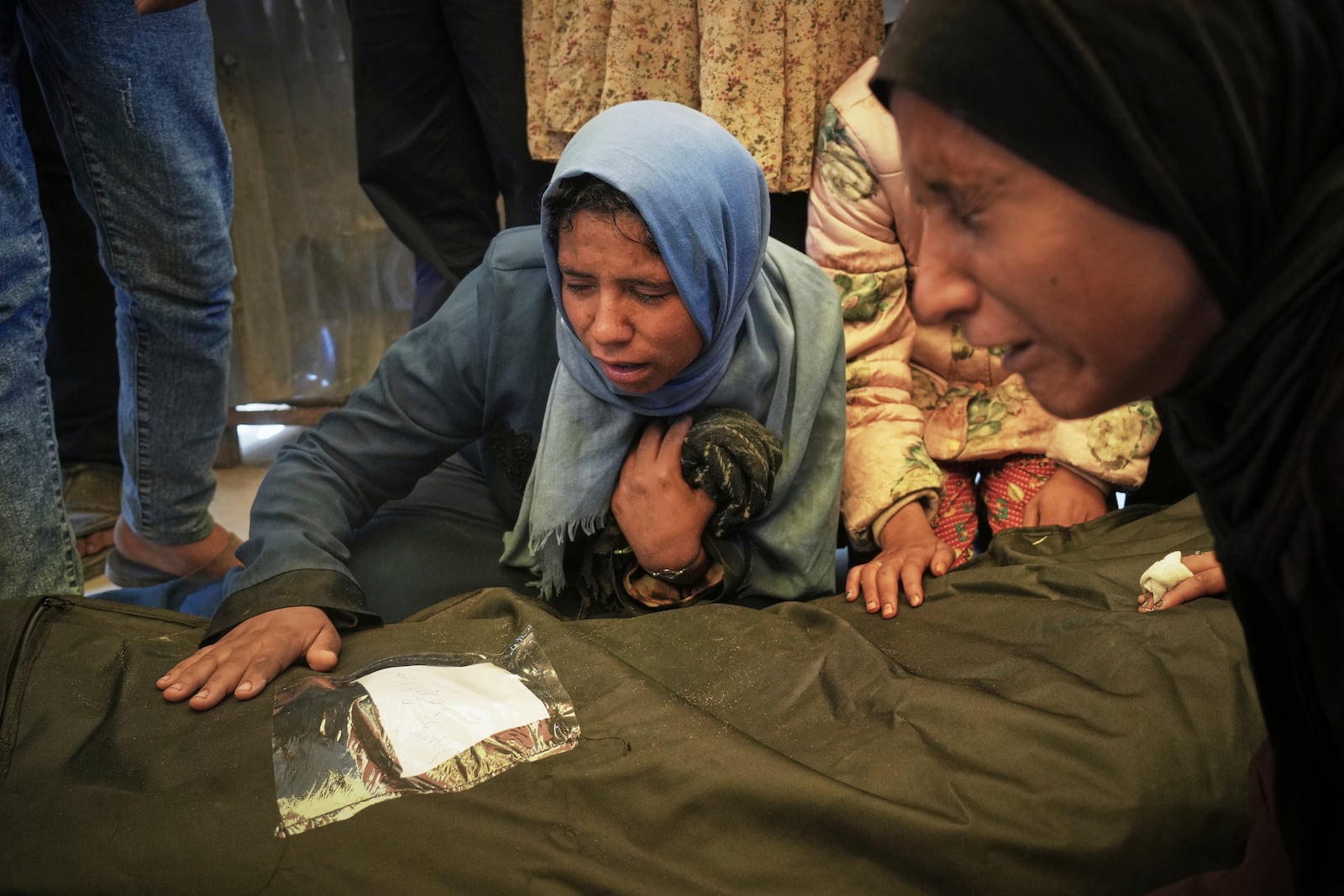 Islam Abu Sahloul mourns the death of her sister Lamia, 32, who was killed when an Israeli army strike hit a house killing at least five members of the Abu Sahloul family, in Khan Younis, in the southern Gaza Strip, Thursday, May 1, 2025. (AP Photo/Abdel Kareem Hana)