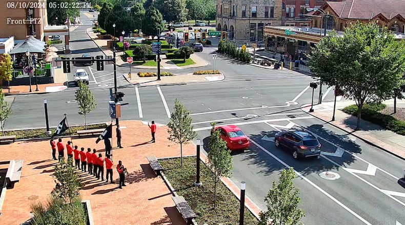 A still image taken from a city of Springfield video camera shows a group carrying Nazi flags and guns demonstrating on the Springfield City Hall plaza at 5 p.m. Aug. 10.