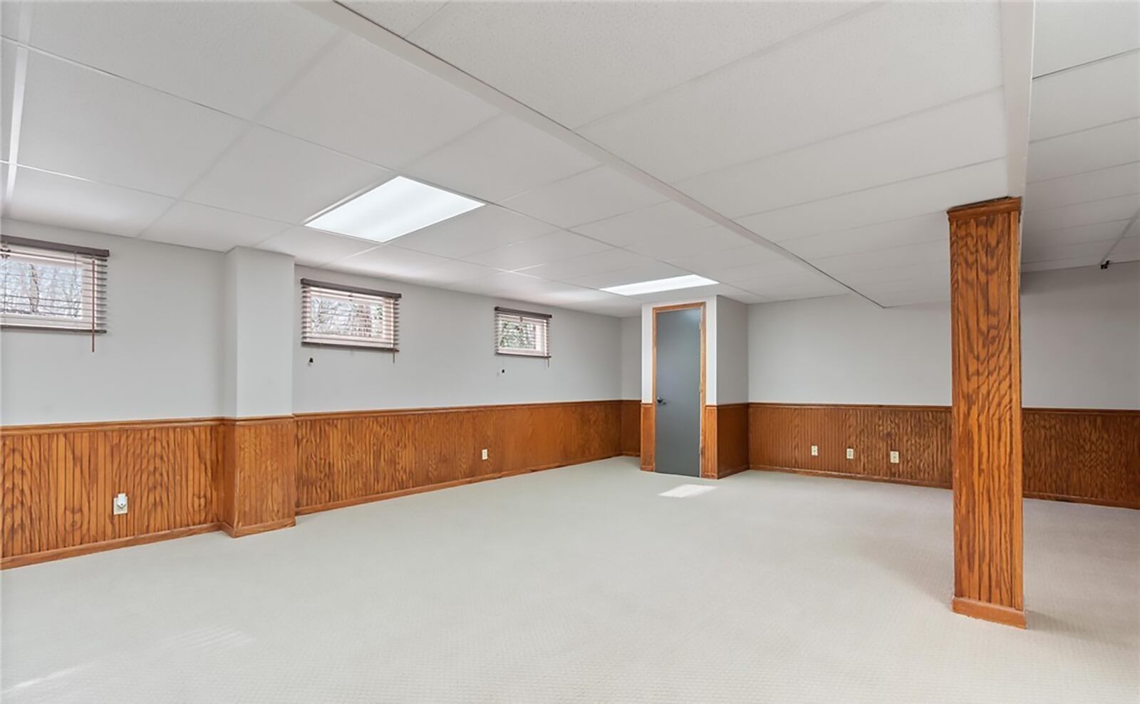 The finished basement has a recreation room with carpeting, wood paneling and ceiling lights. There is also a remodeled half bathroom. CONTRIBUTED