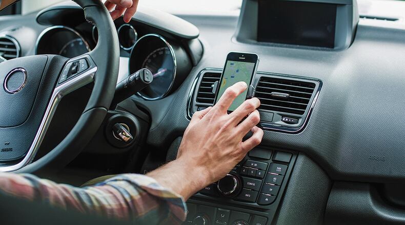 The easiest way to free up your hands for old-fashioned car activities like steering and shifting is to put your phone down. Metro News Service photo