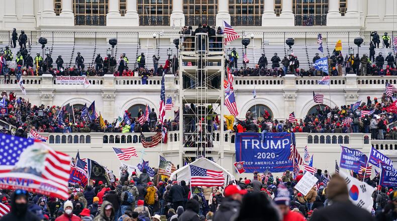 FILE - In this Jan. 6, 2021, file photo insurrectionists loyal to President Donald Trump breach the Capitol in Washington. Prosecutors secured the first guilty plea in the major case brought against members of the Oath Keepers extremist group in the attack on the U.S. Capitol, while an Indiana woman who became first person to be sentenced for the Jan. 6 riot avoided time behind bars. (AP Photo/John Minchillo)