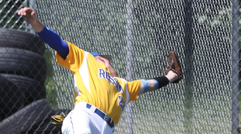 Russia’s Jordan York tumbles backward as he tries to field a foul ball. Bill Lackey/Staff