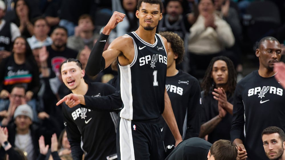 San Antonio Spurs center Victor Wembanyama (1) celebrates a basket during the second half of an NBA basketball game against the New York Knicks, Wednesday, Dec. 31, 2025, in San Antonio. (AP Photo/Darren Abate)