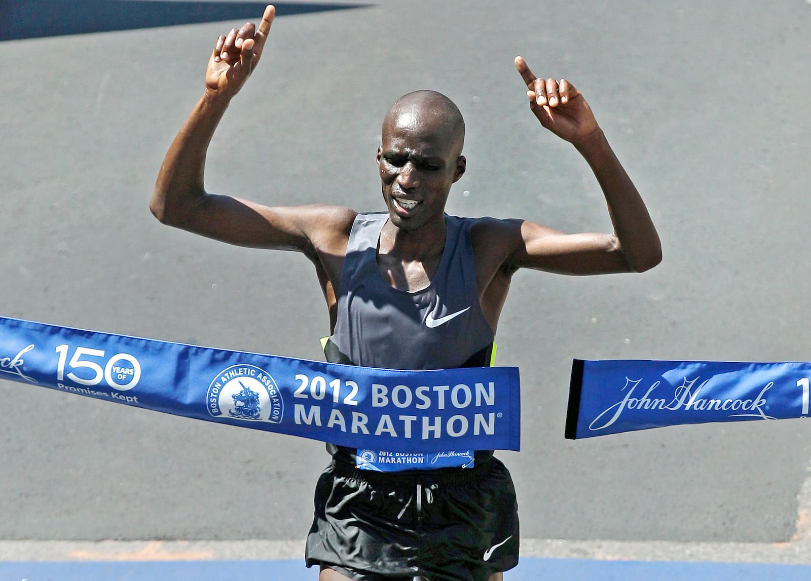 FILE - Wesley Korir of Kenya celebrates as he breaks the tape to win the 116th Boston Marathon in Boston, Monday, April 16, 2012. (AP Photo/Charles Krupa, File)