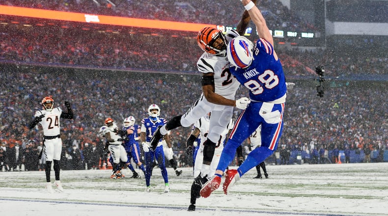Cincinnati Bengals safety Dax Hill (23) breaks up a pass intended for Buffalo Bills tight end Dawson Knox (88) during the third quarter of an NFL division round football game, Sunday, Jan. 22, 2023, in Orchard Park, N.Y. (AP Photo/Adrian Kraus)