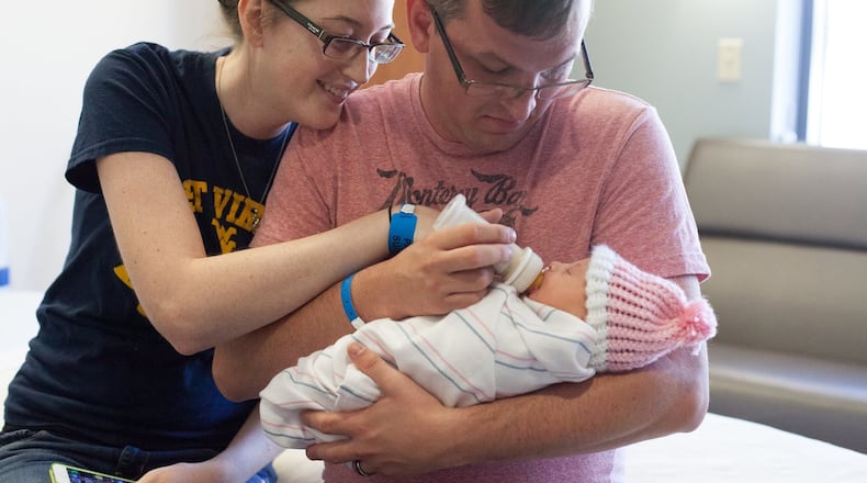 A couple meets their adopted newborn for the first time at Choosing Hope Adoptions. Contributed.