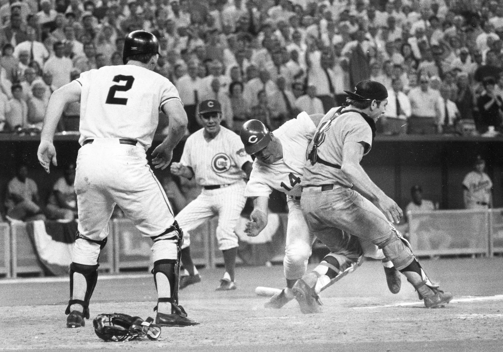 FILE - In this July 14, 1970, file photo, National League's Pete Rose slams into American League catcher Ray Fosse to score the winning run during the 12th inning of the baseball All-Star Game in Cincinnati. Looking on are third base coach Leo Durocher, and on-deck batter Dick Dietz (2). Fosse, the strong-armed catcher whose career was upended when he was bowled over by Pete Rose at the 1970 All-Star Game, has died. He was 74. Carol Fosse, his wife of 51 years, said in a statement Fosse died Wednesday, Oct. 13, 2021, after a 16-year bout with cancer. (AP Photo, File)