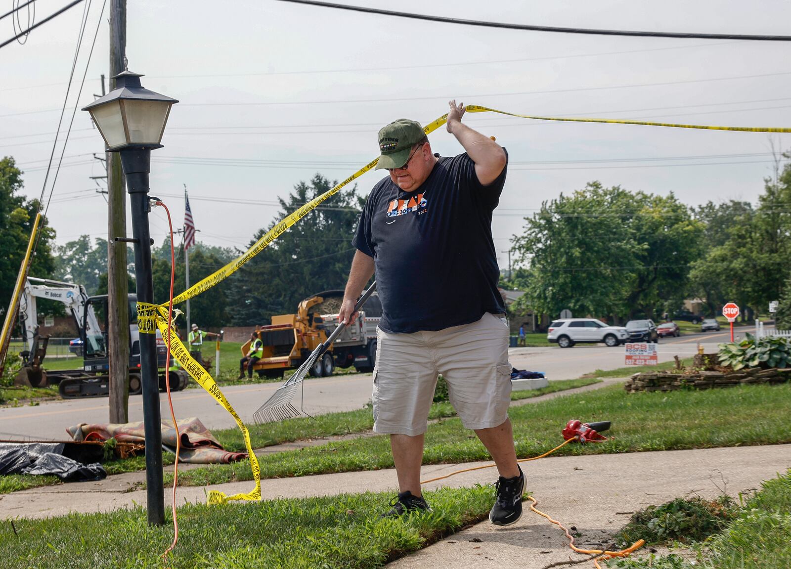 Richard Volzke assess the debris in his yard on Monday, July 21, 2025, following a storm that happened in Moorefield Township. JOSEPH COOKE/STAFF