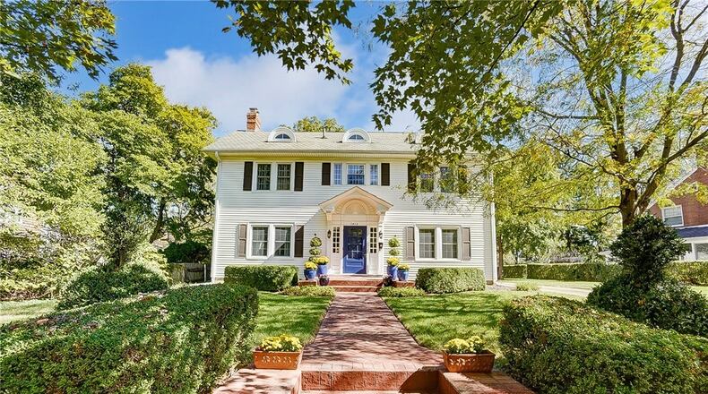 The front of the home has a red brick paver walkway leading to the portico covered front entrance.
