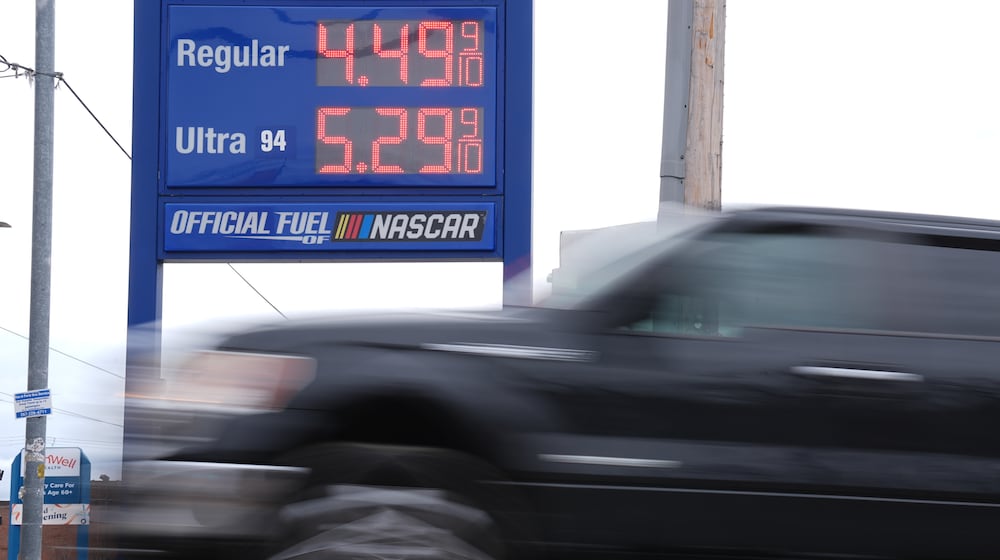 A vehicle passes a gasoline price board at a filling station in Philadelphia, Friday, March 27, 2026. (AP Photo/Matt Rourke)