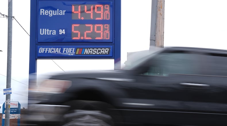 A vehicle passes a gasoline price board at a filling station in Philadelphia, Friday, March 27, 2026. (AP Photo/Matt Rourke)