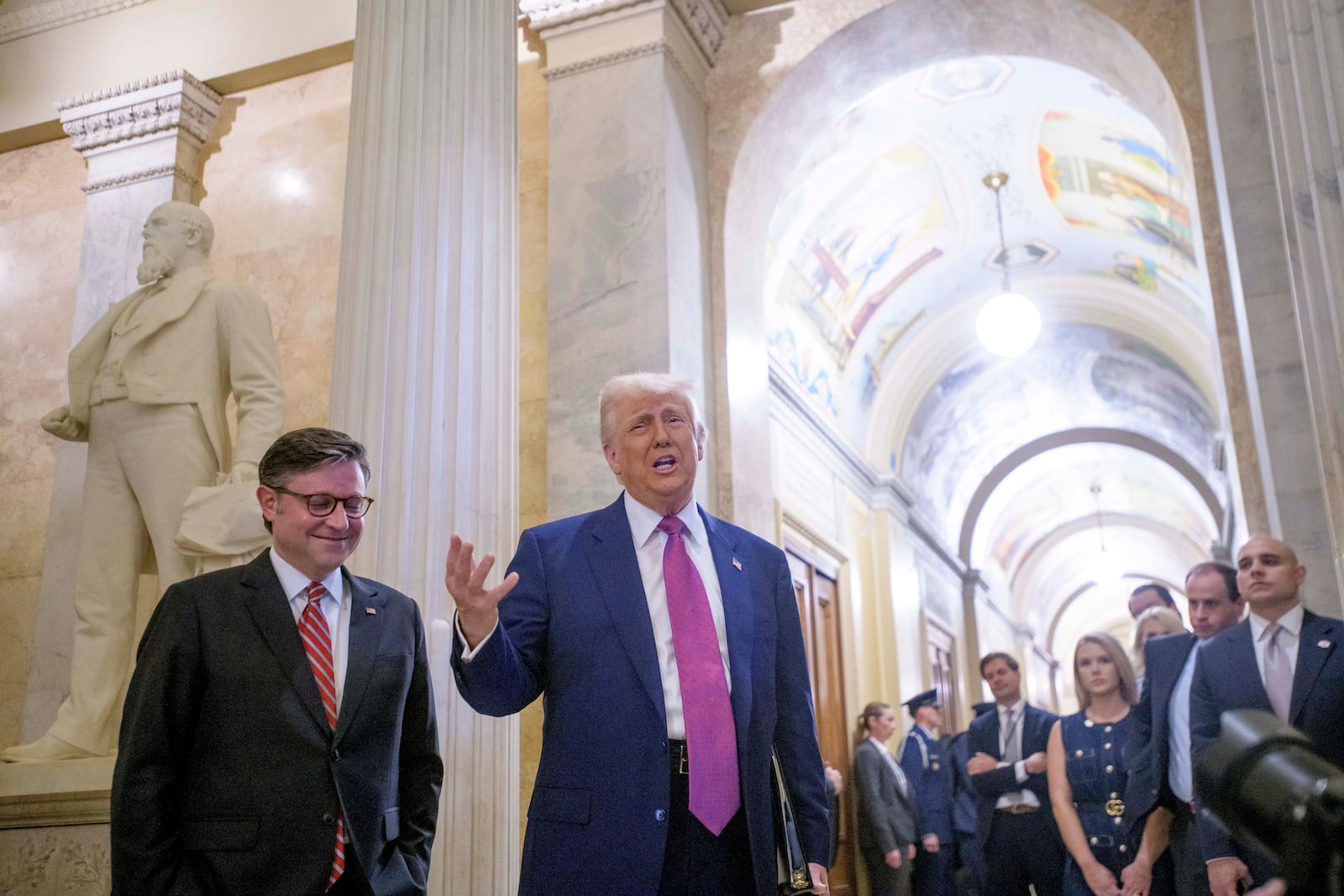 President Donald Trump, right, is joined by Speaker of the House Mike Johnson, R-La., as he arrives for a meeting with the House Republican Conference at the Capitol, Tuesday, May 20, 2025, in Washington. (AP Photo/Rod Lamkey, Jr.)