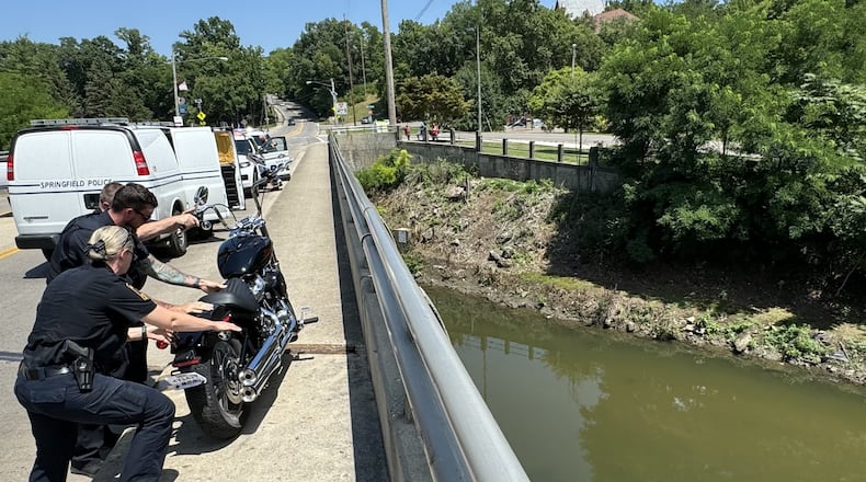 A woman riding a motorcycle was seriously injured Thursday, July 11, 2024, when she apparently lost control on the Plum Street bridge and dropped more than 30 feet into Buck Creek in downtown Springfield. BILL LACKEY/STAFF