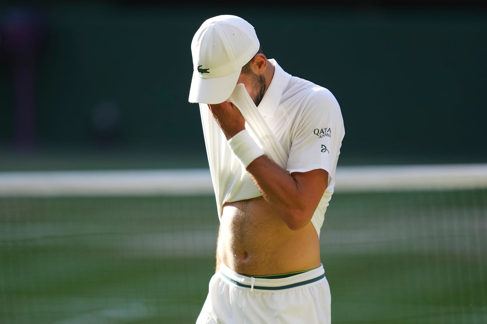 Novak Djorkovic of Serbia reacts during the men's semifinal singles match against Jannik Sinner of Italy at the Wimbledon Tennis Championships in London, Friday, July 11, 2025.(AP Photo/Kirsty Wigglesworth)