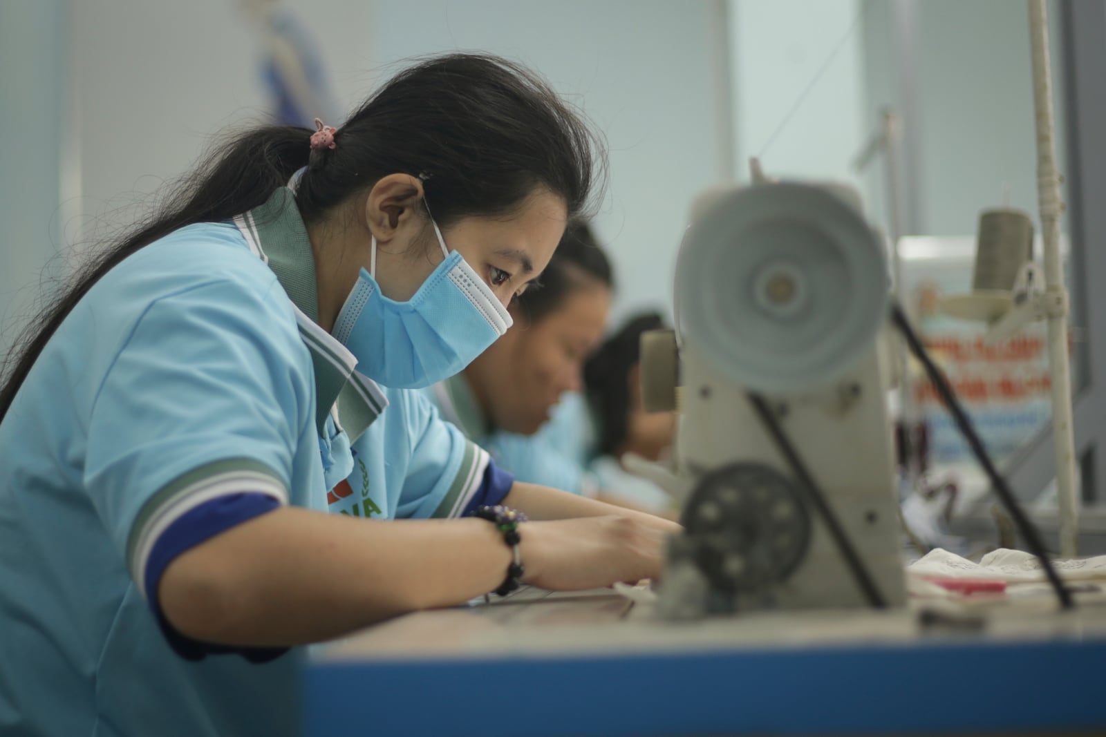 A girl who has health problems because of exposure to Agent Orange practices sewing at a special school In Da Nang, Vietnam, March 7, 2025. (AP Photo/Aniruddha Ghosal)