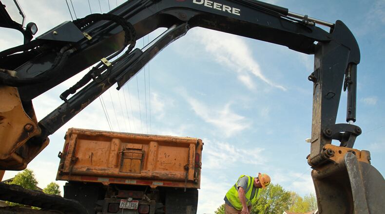 Spray paint on streets and roads means someone's digging, but the colors also mean something specific. JIM WITMER / STAFF