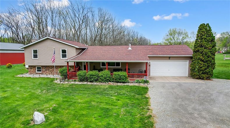 The front of the tri-level home has a two-car attached garage, concrete front patio with full cover and wood railings. CONTRIBUTED PHOTOS