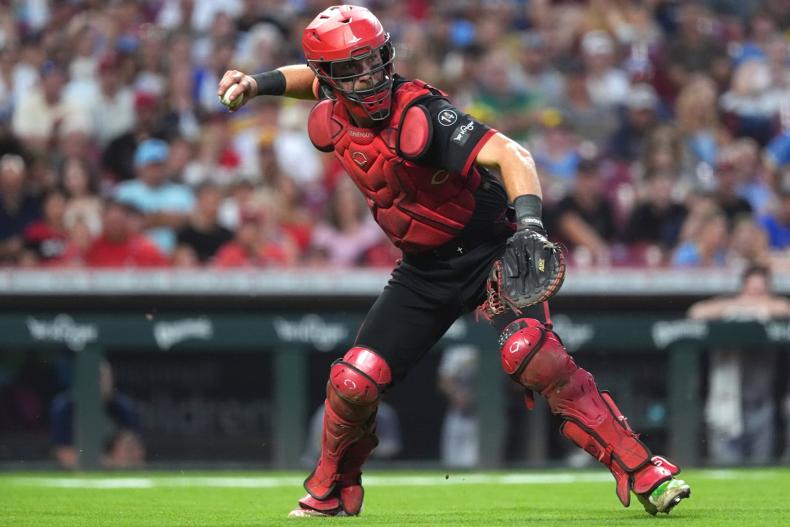 Cincinnati Reds' Tyler Stephenson throws to first base in the fifth inning of a baseball game against the Milwaukee Brewers, Friday, Aug. 15, 2025, in Cincinnati. (AP Photo/Kareem Elgazzar)