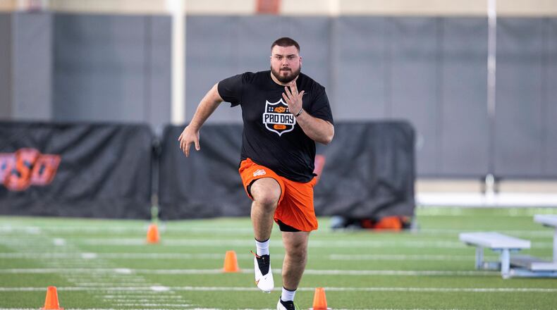 Josh Sills runs a drill during Oklahoma State football pro day in Stillwater, Okla., Thursday, March 24, 2022. (AP Photo/Alonzo Adams)