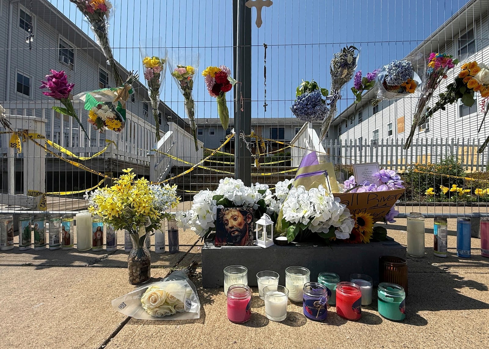 Flowers sit at a makeshift memorial in front of the Gabriel House assisted living facility, where a fire on Sunday killed several people, Wednesday, July 16, 2025 in Fall River, Mass. (AP Photo/Rodrique Ngowi)