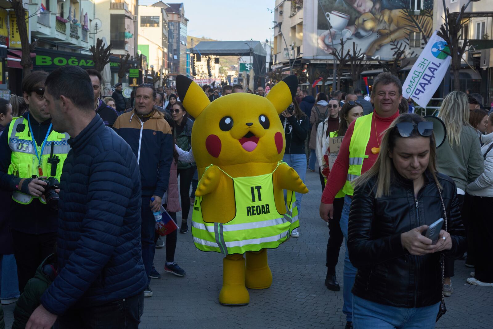 A person dressed in a Pikachu costume walks during an anti-corruption protest led by university students in the southwestern town of Novi Pazar, Serbia, Saturday, April 12, 2025. (AP Photo/Marko Drobnjakovic)