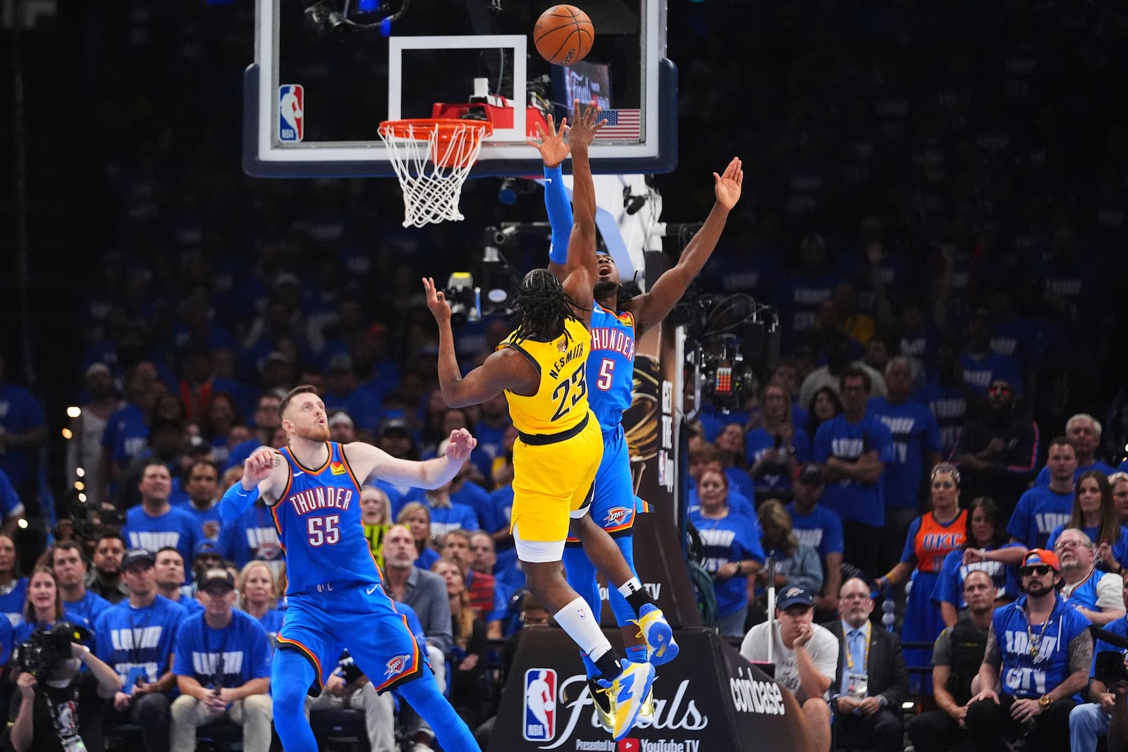 Indiana Pacers forward Aaron Nesmith (23) shoots against Oklahoma City Thunder guard Luguentz Dort (5) during the first half of Game 2 of the NBA Finals basketball series Sunday, June 8, 2025, in Oklahoma City. (AP Photo/Julio Cortez)