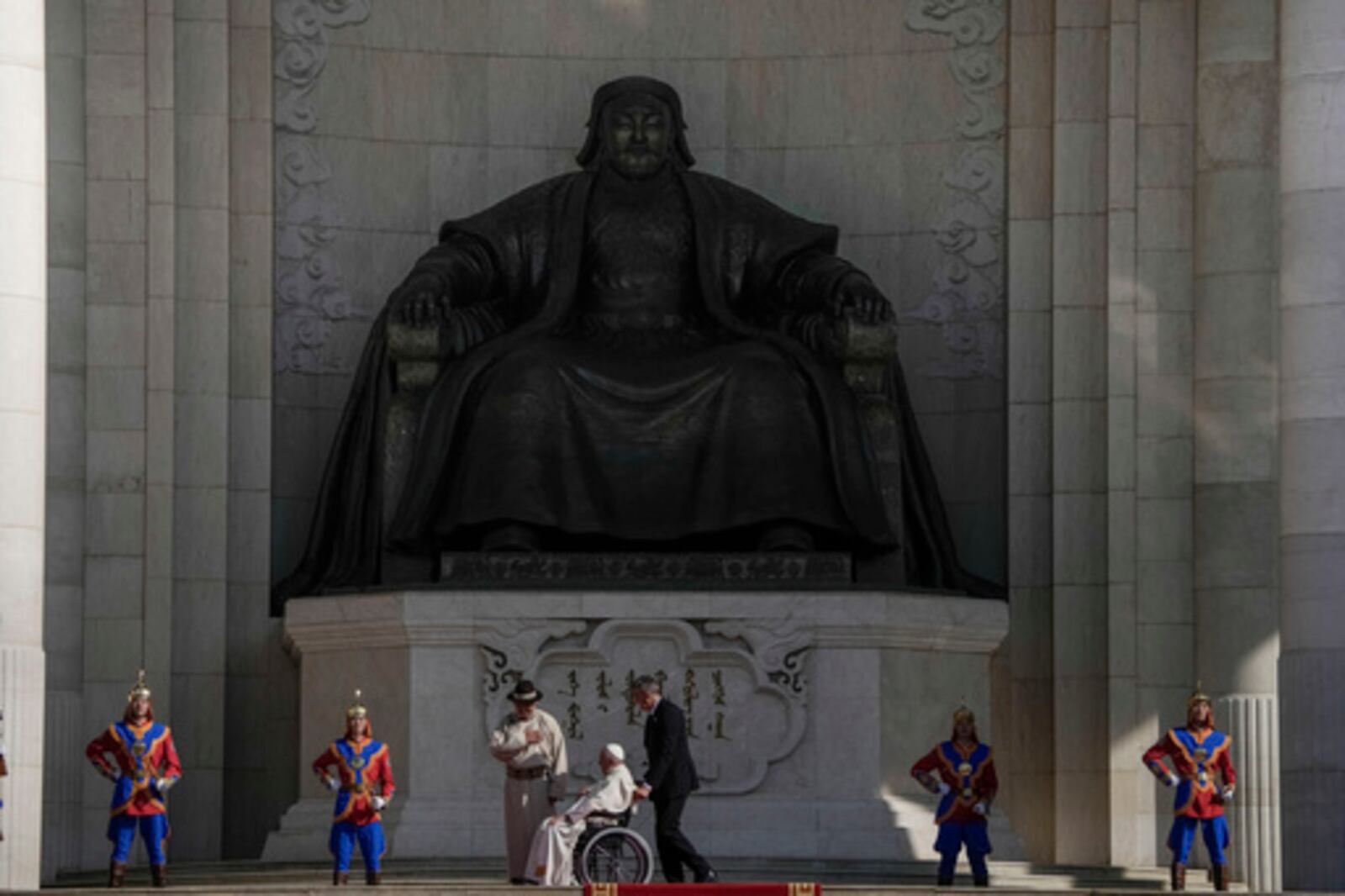 FILE - Mongolian President Ukhnaagiin Khurelsukh, left, and Pope Francis meet in front of a gigantic statue of former Khagan of the Mongol Empire Genghis Khan in Sukhbaatar Square in Ulaanbaatar, Saturday, Sept. 2, 2023. (AP Photo/Ng Han Guan, File)