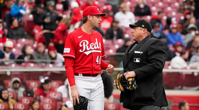 Cincinnati Reds starting pitcher Nick Lodolo (40) talks with home plate umpire Bruce Dreckman, right, during the first inning of a baseball game against the Pittsburgh Pirates, Saturday, April 1, 2023, in Cincinnati. (AP Photo/Joshua A. Bickel)