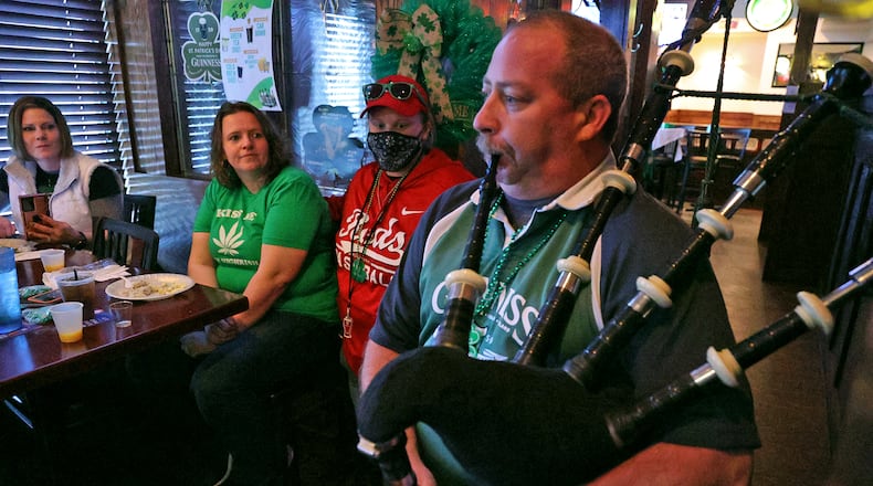 Eric Beverly plays the bagpipes for a group during the St. Patrick's Day celebration at O'Conners Irish Pub Wednesday morning. BILL LACKEY/STAFF