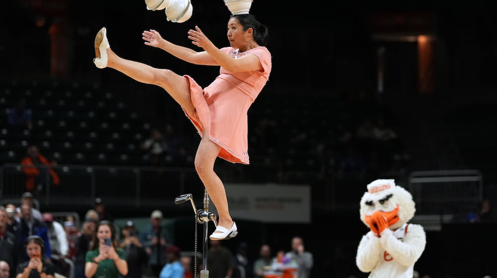 Red Panda performs as Miami's mascot Sebastian the Ibis looks on during halftime of an NCAA college basketball game between Miami and Stanford in Coral Gables, Fla., Wednesday, Jan. 28, 2026. (AP Photo/Rebecca Blackwell)