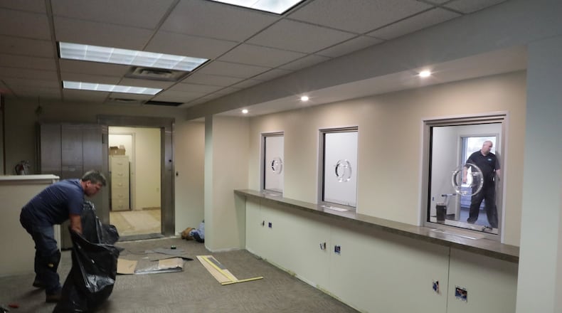 Workers get the new City of Urbana Business Offices ready Tuesday for the department to move in this weekend. The office, which handles finance, income tax, utility billing and human resources, is moving out of the Urbana City Building to the former 5/3 Bank branch located next door. The new offices will be open next Tuesday. BILL LACKEY/STAFF