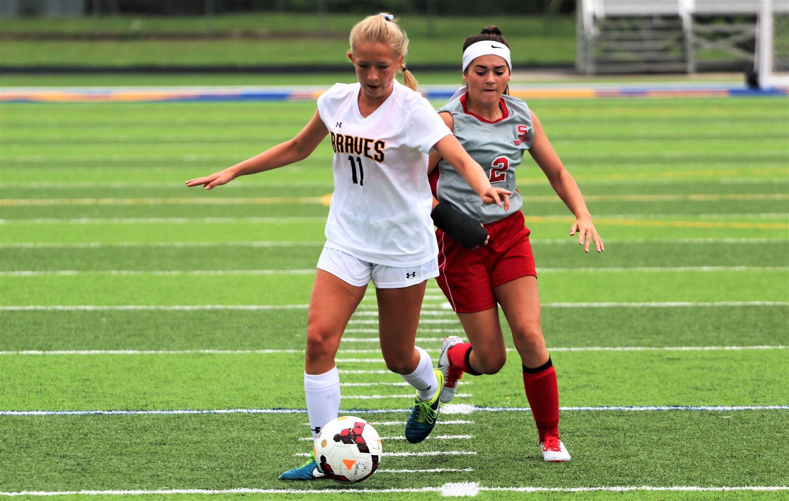 Shawnee High School senior Lena Jenssen (11) dribbles the ball through the Southeastern defense during the first annual Clark County Soccer Preview on Aug. 12 at Evans Stadium in Springfield. Jenssen is the top returning scorer in the Central Buckeye Conference this season, tallying 71 points last season. MICHAEL COOPER / CONTRIBUTED
