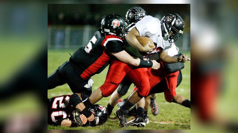Loren Snow (22) of West Carrollton is tackled by Zeke Eier (5) and Kyle Sanning (20) of Tecumseh during Friday's first-round Division II playoff football game on Nov. 6, 2009. BARBARA J. PERENIC / STAFF PHOTO