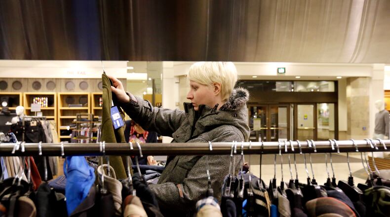 FILE - In this Thursday, Jan. 10, 2013 file photo, a woman shops at a Nordstrom store in Chicago. U.S. consumer prices were flat last month, the latest sign inflation is in check. That could give the Federal Reserve room to continue its efforts to stimulate growth. The consumer price index has risen 1.6 percent in the 12 months ending in January, the Labor Department said Thursday, Feb. 21, 2013. That's down from a 2.9 percent pace a year ago. (AP Photo/Nam Y. Huh, File)