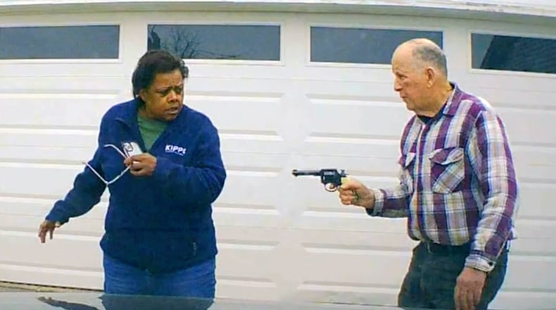 In this image taken from Uber dashcam video released by the Clark County, Ohio, Sheriff's Office, William Brock, right, holds a weapon to Uber driver Loletha Hall outside his home in South Charleston, Ohio, on March 25, 2024. Brock, 81, who authorities say fatally shot Hall who he thought was trying to rob him after scam phone calls deceived them both, was indicted on a murder charge, Monday, April 15, 2024, by a Clark County grand jury. Hall had no knowledge of the calls made to Brock, authorities said. (Clark County Sheriff's Office via AP)