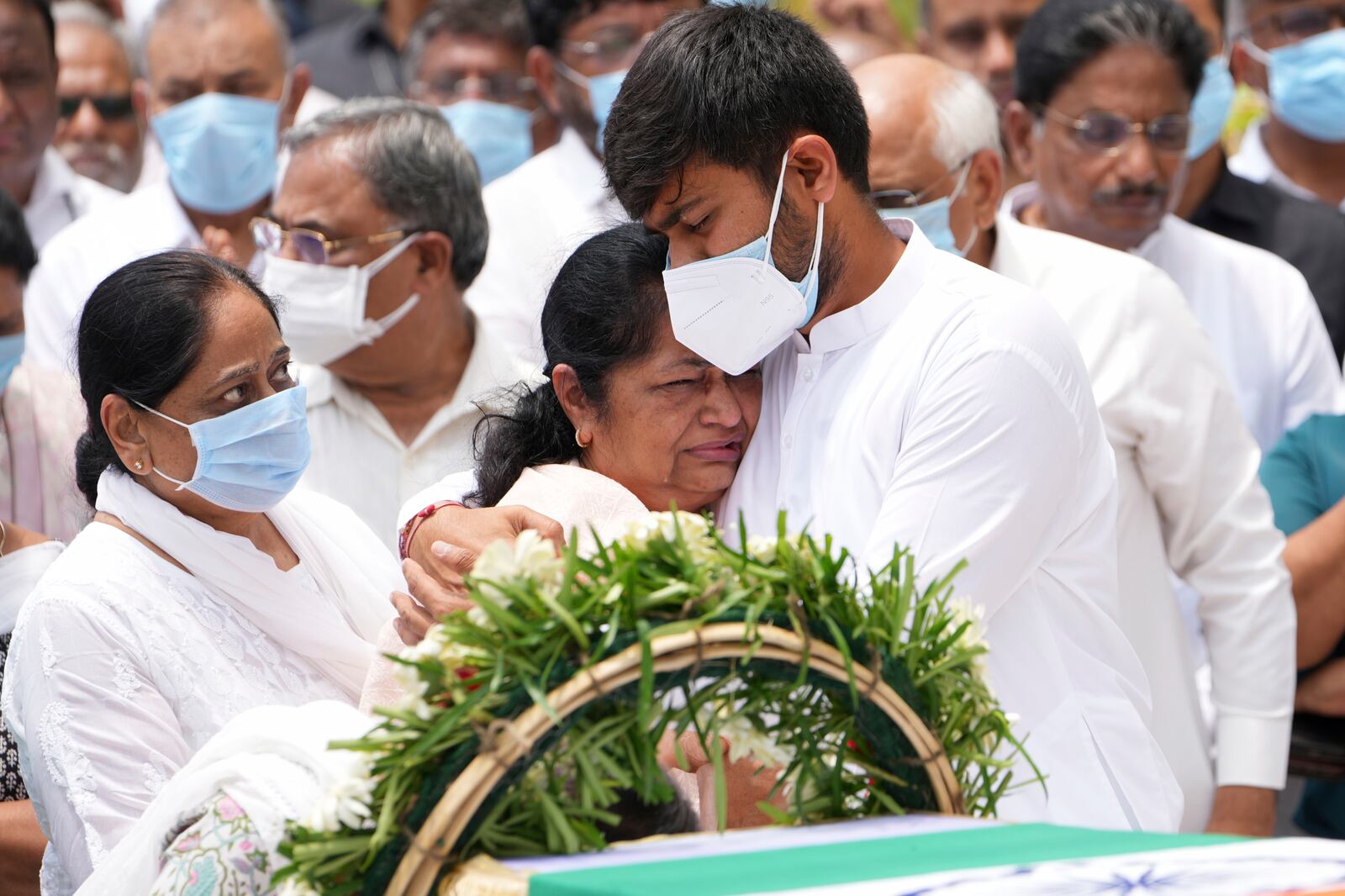 Rushabh Rupani, son of former Chief Minister of Gujarat Vijay Rupani, consoles his mother Anjali Rupani as they receive the body of Vijay Rupani, who died in Thursday's Air India plane crash, in Ahmedabad, India, Monday, June 16, 2025. (AP Photo/Ajit Solanki)