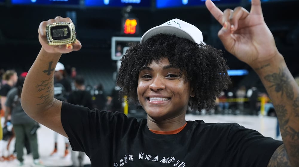 Texas guard Rori Harmon holds her MVP trophy as she and teammates celebrate their win over South Carolina in an NCAA college basketball game in the Players Era tournament in Las Vegas, Thursday, Nov. 27, 2025. (AP Photo/Eric Gay)