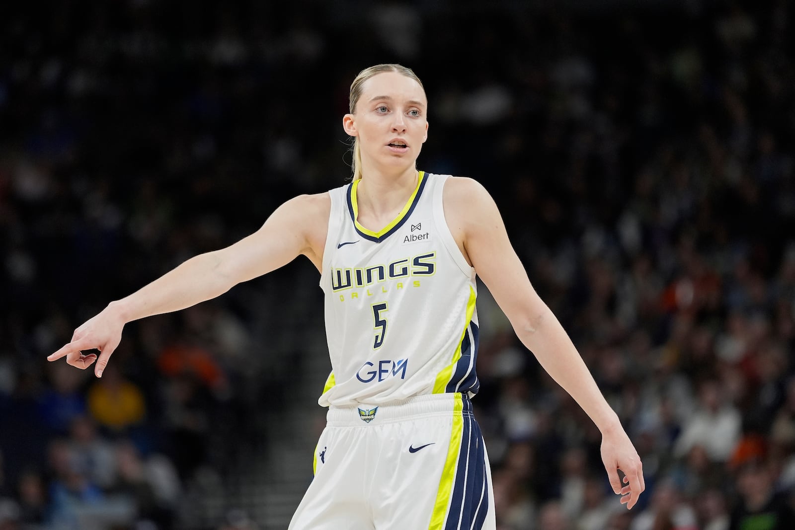 Dallas Wings guard Paige Bueckers (5) points during the first half of a WNBA basketball game against the Minnesota Lynx, Wednesday, May 21, 2025, in Minneapolis. (AP Photo/Abbie Parr)