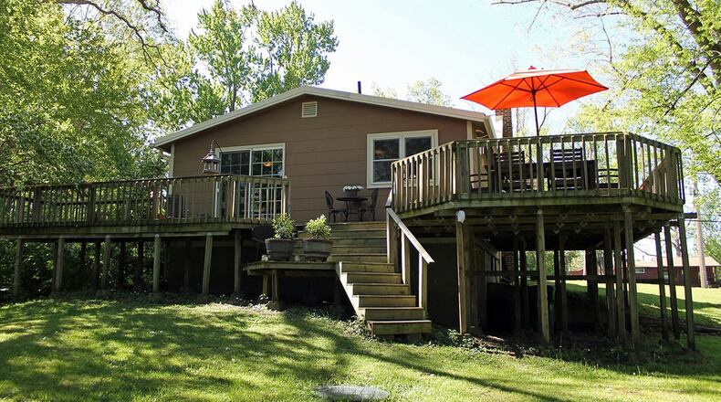 Sliding glass doors in the dining area open to the wraparound deck that overlooks the backyard.