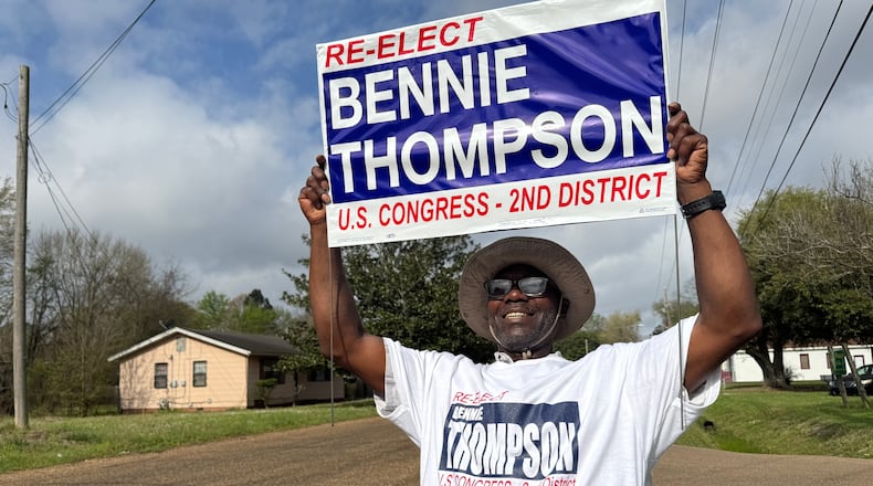 Mark Hopson holds up a campaign sign for U.S. Rep. Bennie Thompson outside a polling location in Jackson, Miss. on Tuesday, March 10, 2026. (AP Photo/Sophie Bates)