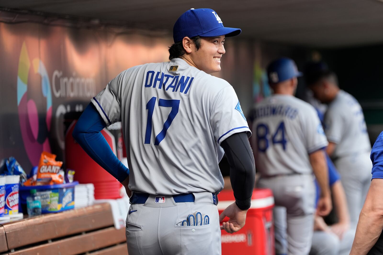 Los Angeles Dodgers Shohei Ohtani smiles in the dugout before the start of a baseball game against the Cincinnati Reds, Tuesday, July 29, 2025, in Cincinnati. (AP Photo/Carolyn Kaster)