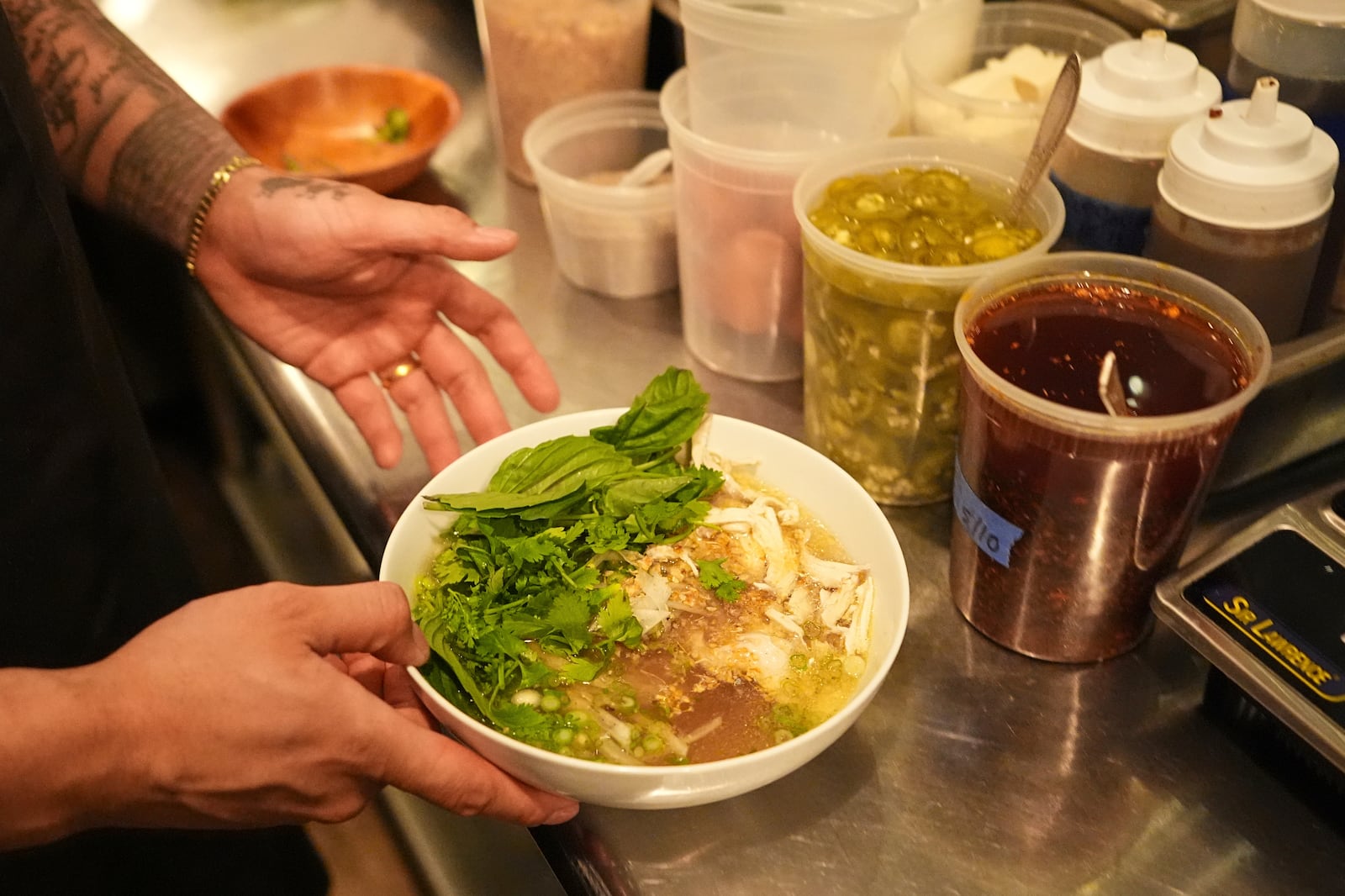 Chef Phila Lorn holds a bowl of the The Mawn Noodle soup at his restaurant, Mawn, in Philadelphia, Thursday, May 22, 2025. (AP Photo/Matt Rourke)