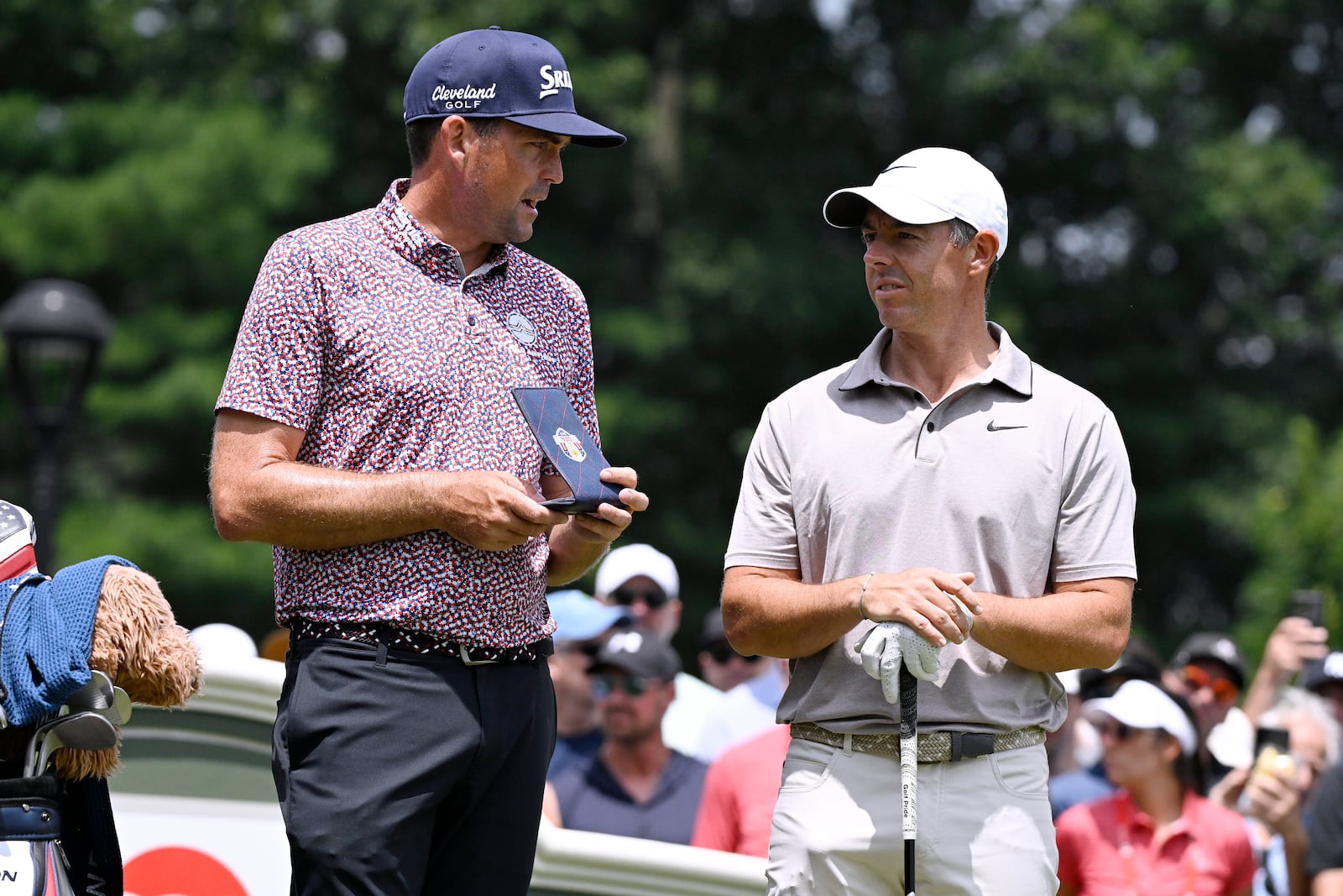 Keegan Bradley, left, talks with Rory McIlroy, right, of Northern Ireland, as they start the second round second round of the Travelers Championship golf tournament at TPC River Highlands, Friday, June 20, 2025, in Cromwell, Conn. (AP Photo/Jessica Hill)