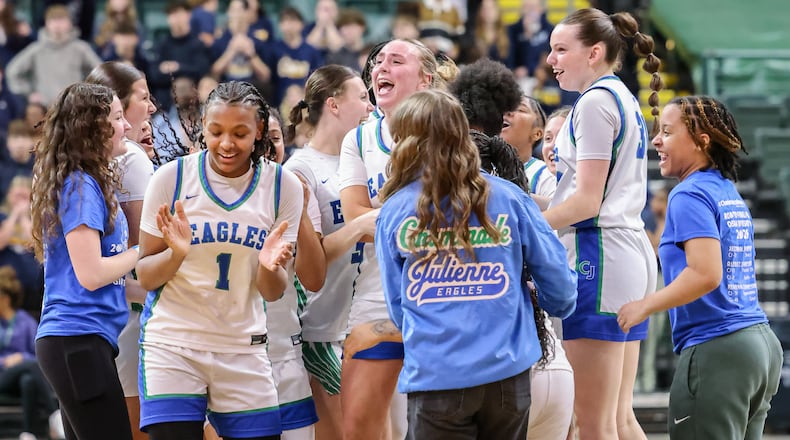 Chaminade-Juliene players celebrate after defeating Copley 62-57 in a Division III state semifinal on Thursday, March 12 at Ervin J. Nutter Center in Fairborn. BRYANT BILLING / STAFF