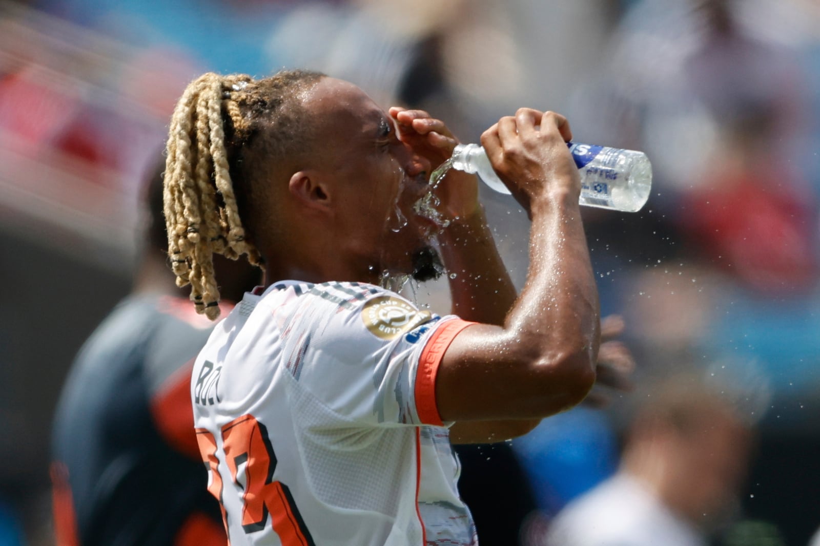Bayern Munich's Sacha Boey poors water on his face during the Club World Cup Group C soccer match between Benfica and Bayern Munich in Charlotte, N.C., Tuesday, June 24, 2025. (AP Photo/Nell Redmond)