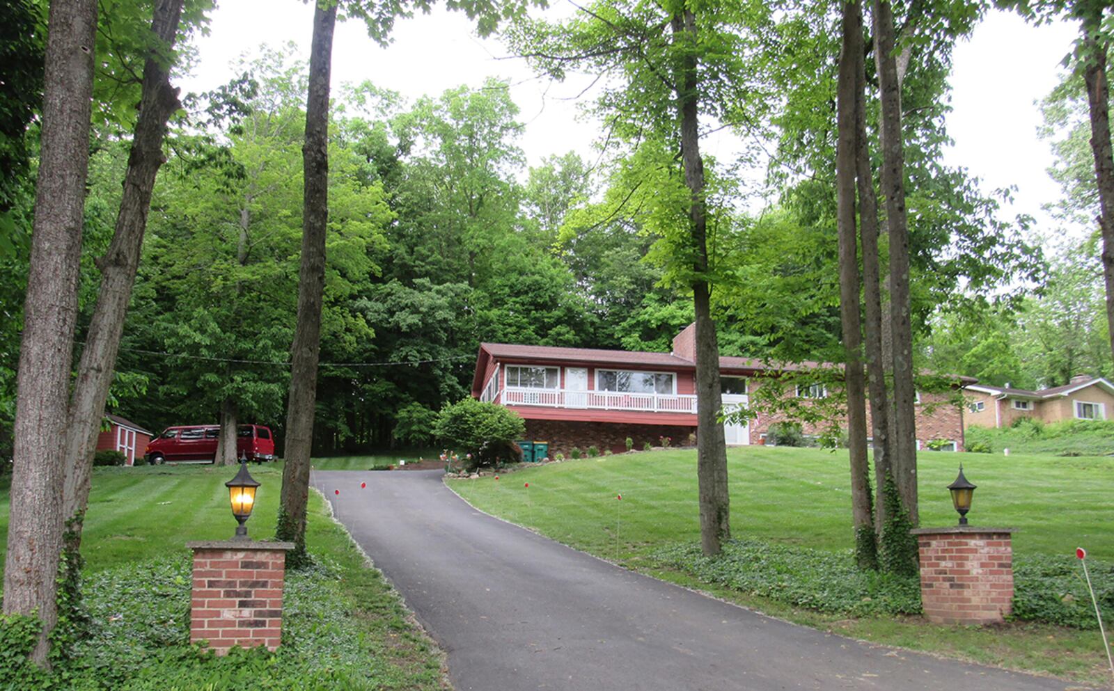 The front the home features a 50-foot asphalt driveway that leads to a side-entry, 3-car garage and storage shed. The front also has an oversized wood deck/balcony with railings. CONTRIBUTED PHOTO