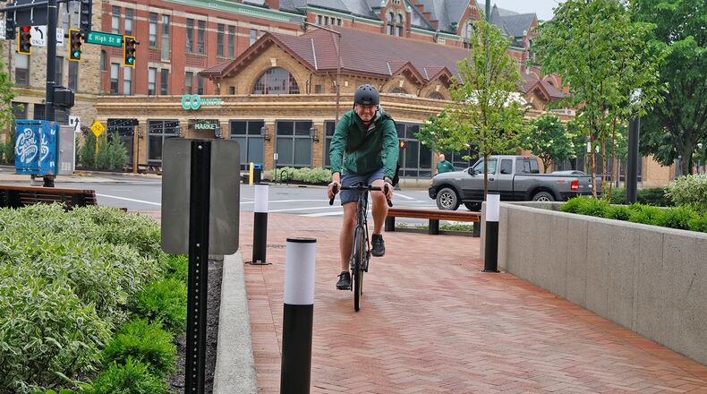 Kevin Rose rides his bike through the City Hall Plaza for the Bike to Work Day event Friday, May 17, 2024. The weather didn't cooperate, but several die-hard cyclists made the ride in the rain for the Bike to Work Day Springfield event. BILL LACKEY/STAFF