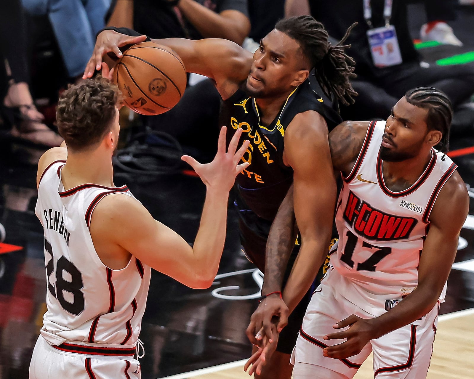 Golden State Warriors' Kevon Looney (5) grabs a rebound in the first half against the Houston Rockets in Game 7 of an NBA basketball first-round playoff series in Houston, Sunday, May 4, 2025. (Carlos Avila Gonzalez/San Francisco Chronicle via AP)