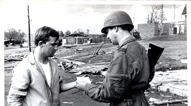 This photo by Photographer Bob Doty from the Dayton Daily News archives ran in the Journal Herald on May 13, 1969. According to the archives, Danny Critchlow is pictured being given a pass by Ohio National Guard Sgt. John Kniffin five days after a powerful tornado struck Kettering and Beavercreek Twp. FILE
